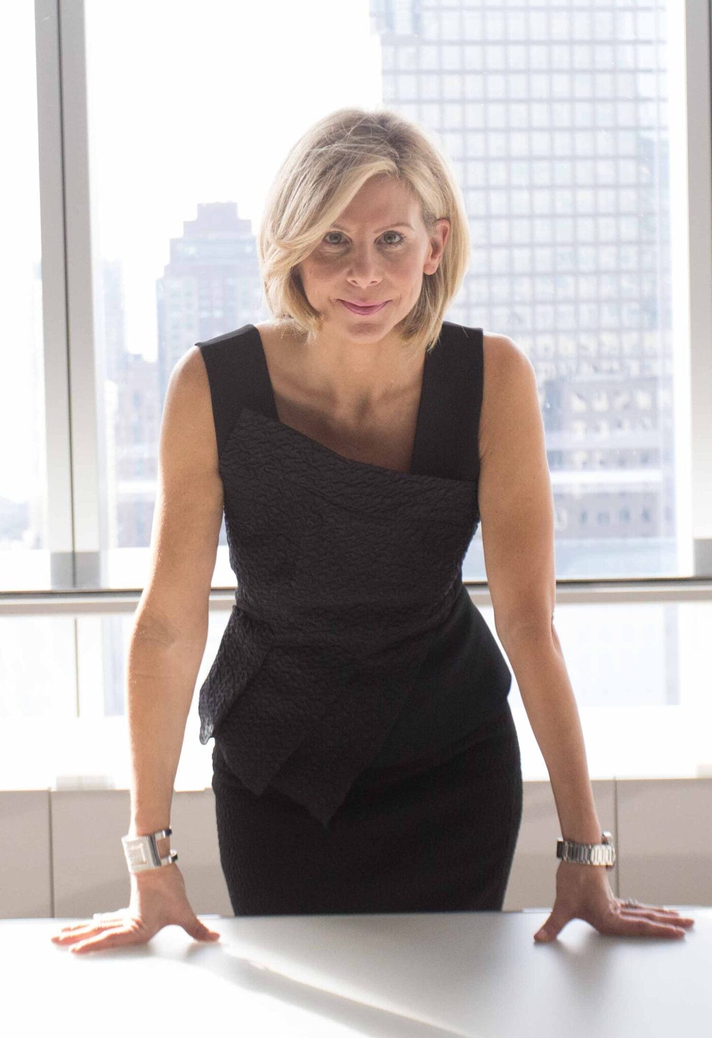 Debra Bednar-Clark, executive advisor, standing in a modern professional setting