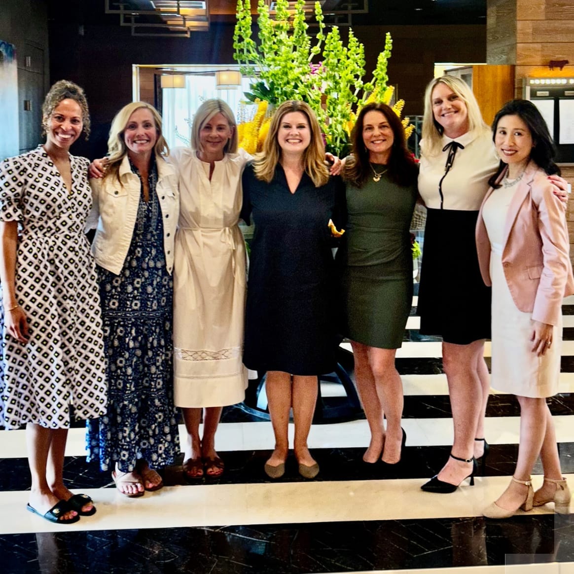 Debra Bednar-Clark standing with a group of women leaders at a professional leadership event